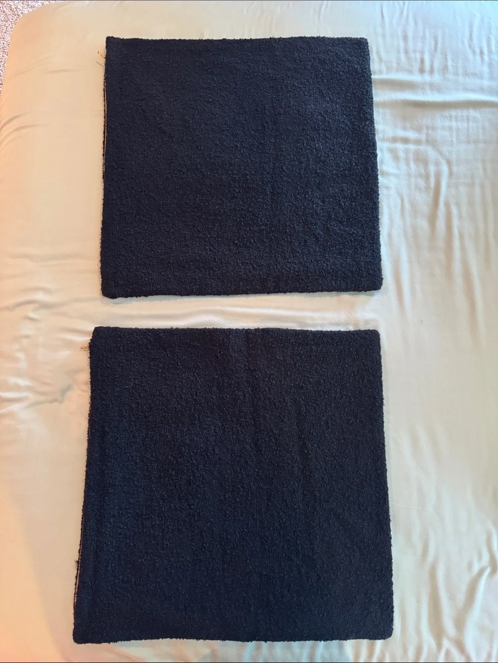 Two CB2 20x20in black boucle pillow covers